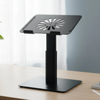 Black adjustable laptop stand on a desk with a blurred background